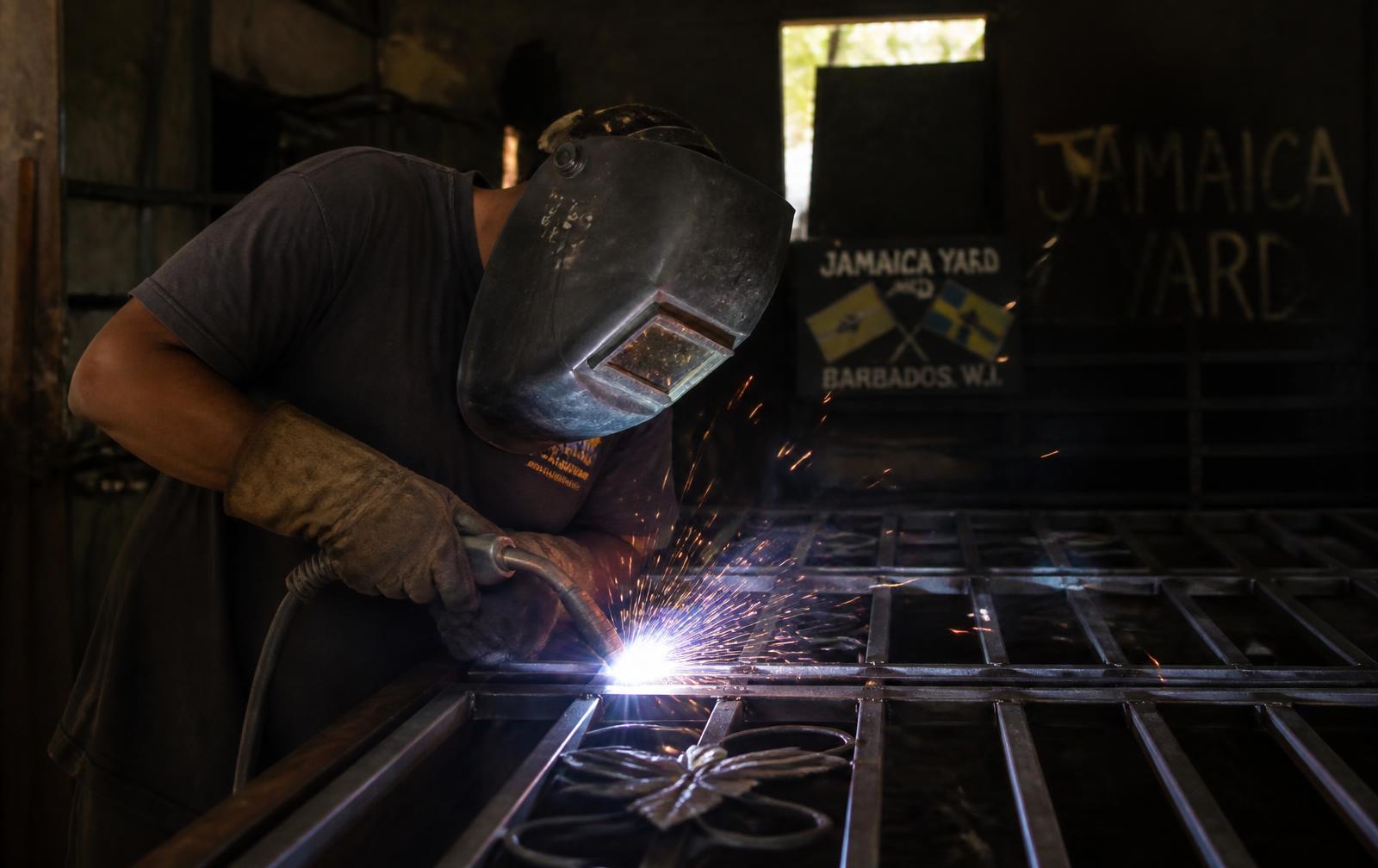 Welder at 3 G's Welding and Automotive fabricating a steel gate in the workshop